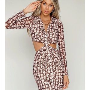 Long sleeve button down dress with waist cut out and ruching details.